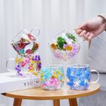 Set of dried flower double wall glass mugs in mixed colors on table