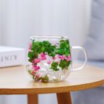 Double wall mug with green leaves and pink flowers