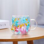 Glass mug with pink blue and yellow dried flowers