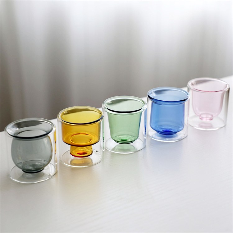 Five colored double wall espresso cups in a row Five colored double wall espresso cups in a row
