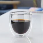 Black coffee in a clear double wall glass cup
