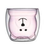 Two bear shaped latte glasses on wooden coasters