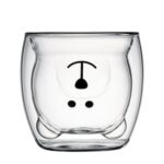 Bear shaped double wall cup with coffee on rattan mat