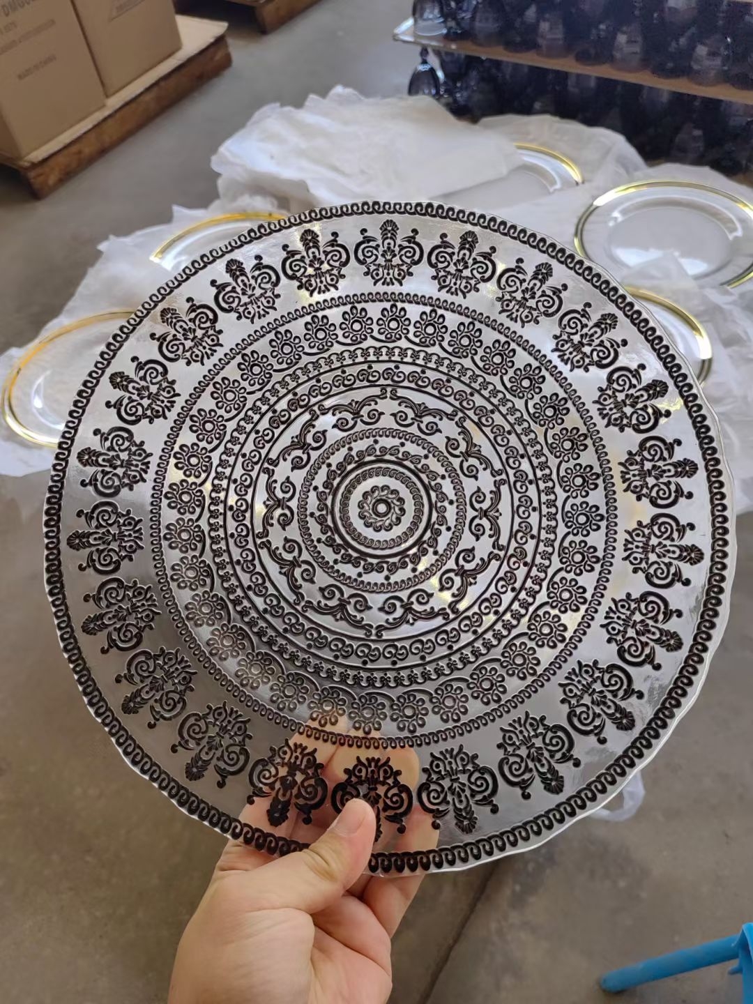Silver mandala decal glass charger plate on work table