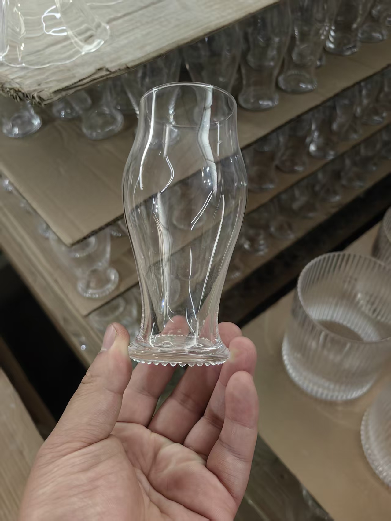 Handmade crystal glass stemmed champagne glass held in workshop
