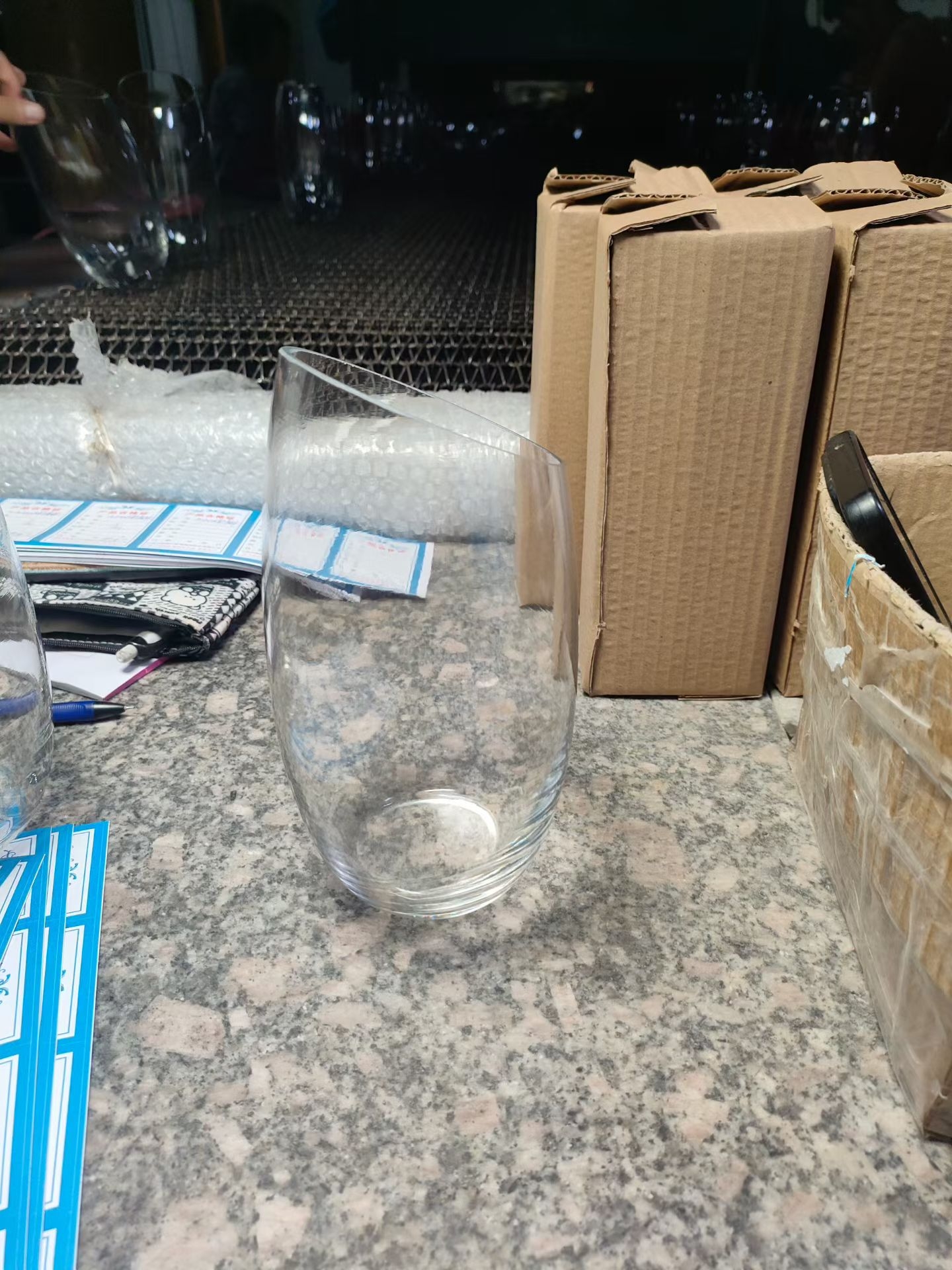 Tapered clear glass bud vase at the packing station