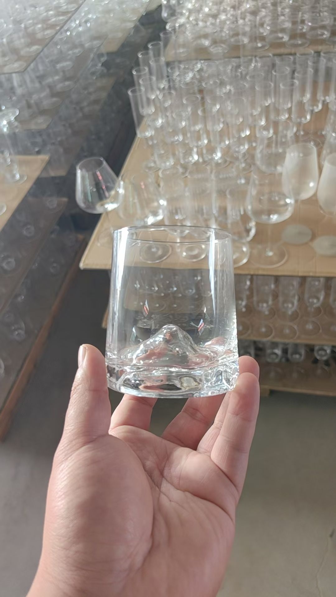 Handmade clear glass whiskey nosing glass held in workshop