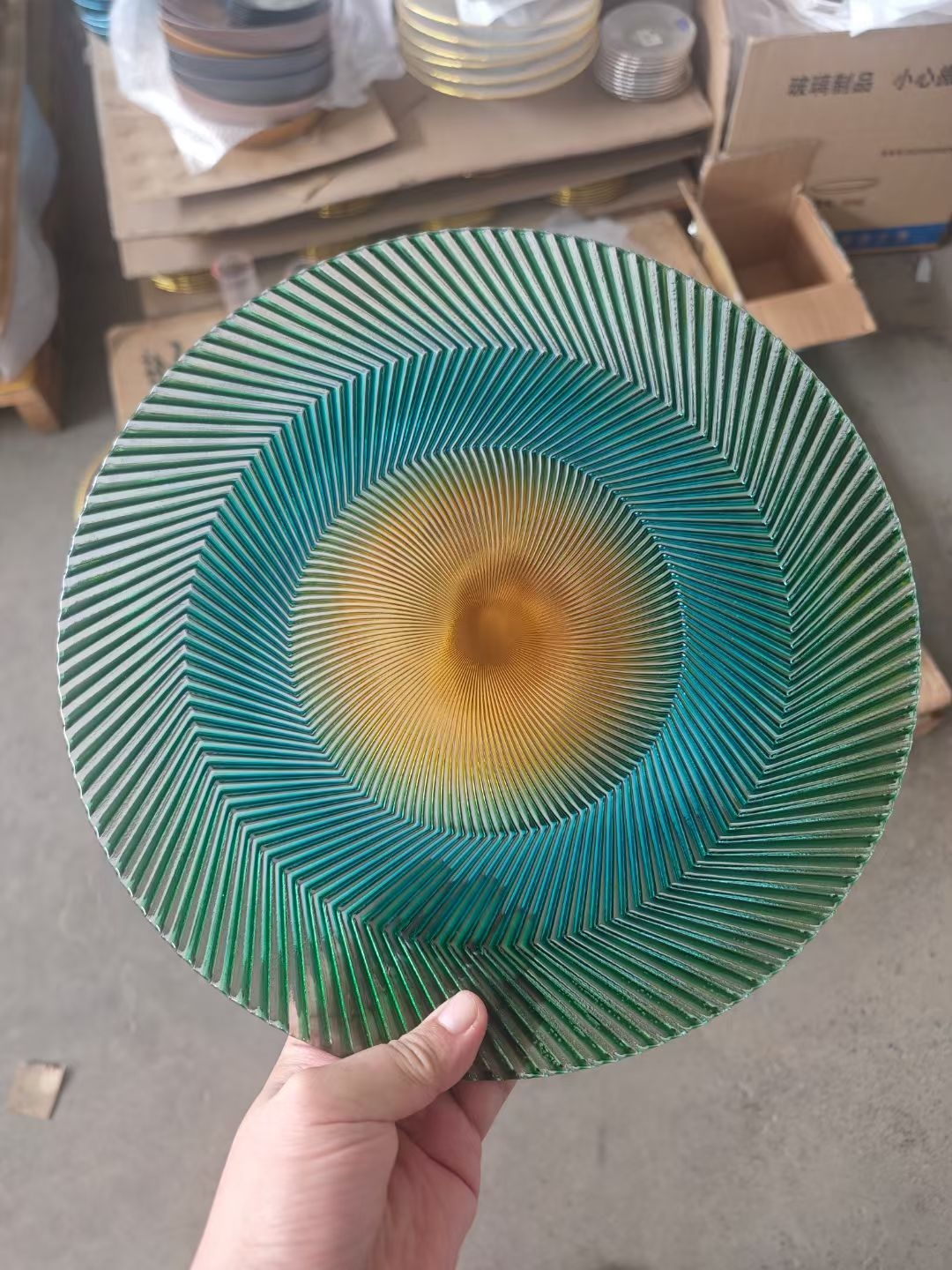 Teal and amber iridescent sunburst glass charger plate