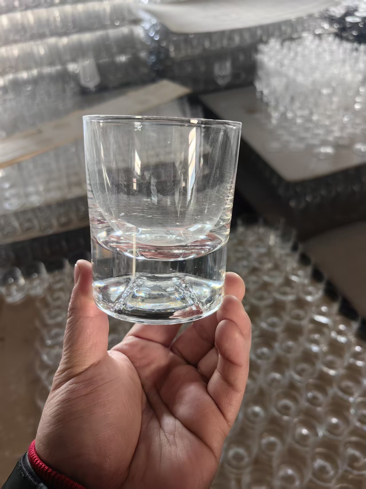 Clear handmade crystal glass tumbler on the production line