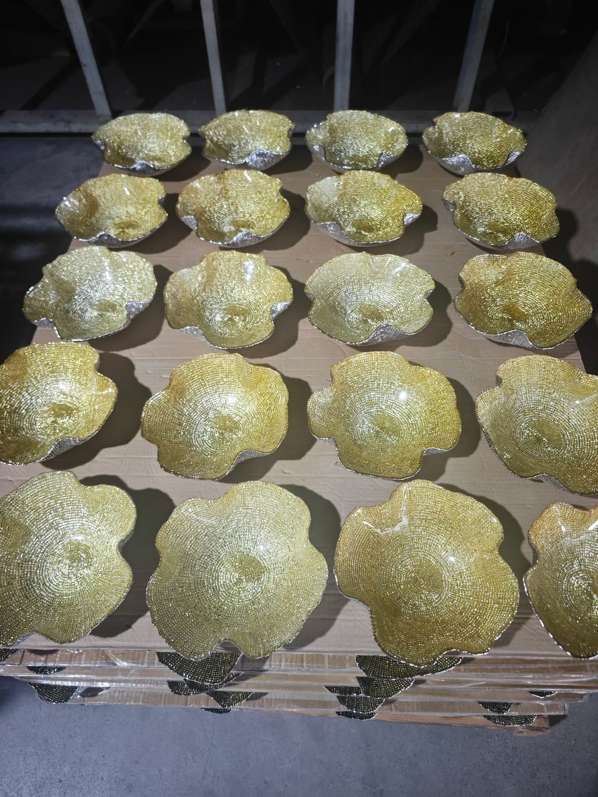 Handmade gold petal shape glass bowls on shipping pallet ready to ship